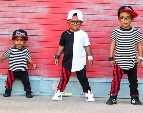 toddlers posing for a shoot with their brothers. 